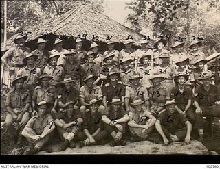 Lae, New Guinea. 1944-06-29. A group portrait of Captain W. H. C. Stretch, Quartermaster, with his cooks and other staff members at HQ, New Guinea Force