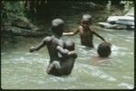 Girls swimming in the creek running by Uka'oi