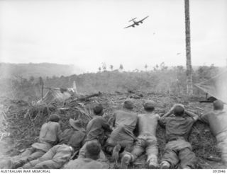 Personnel of D Company, 2/5 Infantry Battalion, watch, from the cover of the ridge, RAAF Beaufort Aircraft bombing and strafing Ulum Ridge, 350 yards across the gully