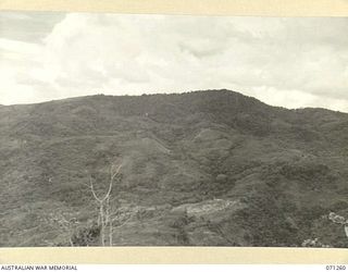 FINSCHHAFEN AREA, NEW GUINEA. 1944-03-18. ONE OF THREE PHOTOGRAPHS FORMING A PANORAMA OF SATTELBERG VIEWED FROM KUANKO. (JOINS WITH NOS. 71261 AND 71262)