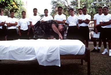 STAFF SGT. Dan Lee, a staff member of the Hawaii National Guard Youth Challenge program, teaches newcomers the proper way to make a bed during the quasi-military residential phase. This federally funded program targets at-risk kids between 16 and 18 years old and tries to steer them away from trouble while they complete their high school requirements.(Published in AIRMAN Magazine May 1996 ) Exact Date Shot Unknown