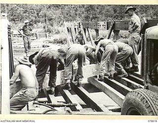 DANMAP RIVER, NEW GUINEA. 1945-01-26. TROOPS OF THE 2/14TH FIELD COMPANY WORKING ON THE CONSTRUCTION OF A PERMANENT 300 FOOT GIRDER BRIDGE ACROSS A RIVER