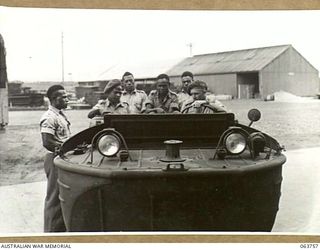 1944-01-26. AUSTRALIAN AND NEW GUINEA ADMINISTRATION UNIT NATIVES BEING TAKEN FOR A RIDE IN AN AMPHIBIOUS JEEP BY LIEUTENANT ROBERTS, AUSTRALIAN ARMOURED CORPS AT THE FACTORY OF THE FORD MOTOR ..