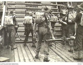 KILIGIA, PAPUA, NEW GUINEA. 1944-04-03. A MORTAR DETACHMENT OF THE 101ST BRIGADE SUPPORT COMPANY, HEADQUARTERS 5TH DIVISION EQUIPPED WITH A 4.2 INCH MORTAR AWAITING THE LOWERING OF THE RAMP OF A ..
