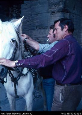 Arles saddling up a horse