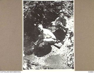 PAPUA, NEW GUINEA. 1942-10. PRESS CORRESPONDENTS IN THE FORWARD AREA NEAR IORIBAIWA RIDGE AT A CREEK NEAR THEIR CAMP