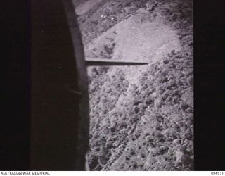 OVER MAPRIK AREA, NEW GUINEA. 1945-05-06. RATIONS AND STORES FOR UNITS OF THE 17 INFANTRY BRIGADE SUPPLIED BY HQ COMMAND, AUSTRALIAN ARMY SERVICE CORPS, 6 DIVISION, BEING DROPPED FROM A 36 ..