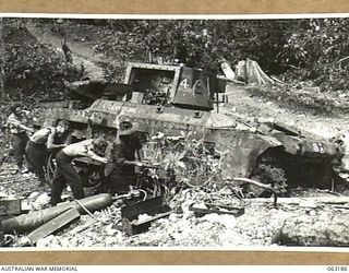 FINSCHHAFEN AREA, NEW GUINEA.  PERSONNEL OF THE 1ST TANK GROUP BATTALION WORKSHOPS CANNIBALISING A DAMAGED TANK FOR PARTS.  THE 'CALAMITY JANE' TURRET WAS LATER USED IN TESTS OF AN 'ALL ROUND ..