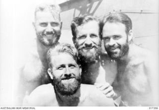 New Guinea. 1944-05. Four bearded RAN sailors. They are Able Seaman J. Coop of Darley, Vic; Leading Stoker W. A. Bone of Bondi, NSW; Signalman R. W. Campell of Randwick, NSW; and (front) Able ..