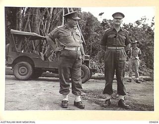 NANTAMBU, NEW BRITAIN, 1945-07-26. LIEUTENANT-COLONEL EDWARDS, COMMANDER, PACIFIC ISLANDS REGIMENT (1), TALKING WITH BRIGADIER-GENERAL C.R.V. EDGAR, COMMANDER 4 INFANTRY BRIGADE (2), AFTER A COURT ..