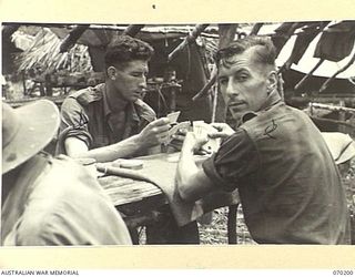 KOROPA, NEW GUINEA. 1944-02-03. VX76913 CORPORAL G.H. MASON (1) AND NX94592 CORPORAL J. ALLAN (2) OF THE 7TH DIVISION PROVOST COMPANY, PICTURED PLAYING CARDS. THE COMPANY'S DUTIES INCLUDE THE ..