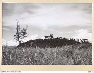 LAE, NEW GUINEA, 1945-11-26. MOUNT LUNAMAN, LAE. BETWEEN THE POINT WHERE THIS WAS TAKEN AND THE FOOT OF THE HILLOCK WAS ONCE THE CHINATOWN OF LAE, OF WHICH NOTHING NOW REMAINS