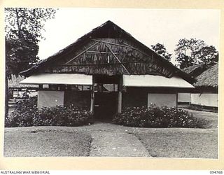 LAE AREA, NEW GUINEA, 1945-08-10. THE EXTERIOR OF THE STUDY HUT, 112 CONVALESCENT DEPOT, ONE OF THE EDUCATION CENTRES UNDER THE COMMAND OF THE DEPUTY ASSISTANT DIRECTOR OF EDUCATION, LAE BASE ..