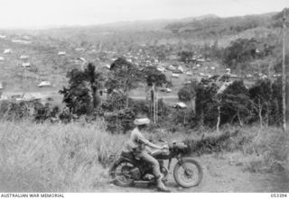 Donadabu, New Guinea. 1943-06-29. A section of the Donadabu training camp, in the Sogeri Valley, occupied by the 7th Australian Brigade and the 2/5th Australian Field Regiment. A despatch rider on ..