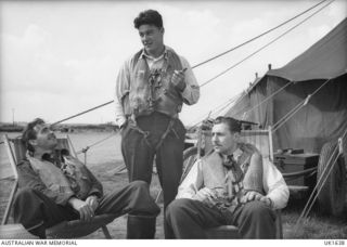 ENGLAND. 1944-07-25. RAAF FIGHTER PILOTS WITH NO. 56 SQUADRON RAF. LEFT TO RIGHT: 420315 PILOT OFFICER (PO) K. WATTS, NARRABEEN LAKES, NSW; 413935 FLYING OFFICER L. J. HENDERSON, SAMARAI, PAPUA; ..