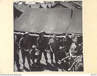 CAPE WOM, NEW GUINEA. 1945-09-29. MEMBERS OF 2/3 INFANTRY BATTALION PLAYING "TWO UP" IN THEIR CAMP AREA