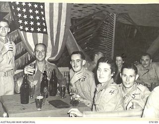 LAE, NEW GUINEA. 1944-09-25. GUESTS ENJOYING THEMSELVES DURING THE OFFICIAL OPENING OF NO. 1 SERGEANTS' MESS, HEADQUARTERS NEW GUINEA FORCE. IDENTIFIED PERSONNEL ARE:- QX31809 STAFF SERGEANT J. ..