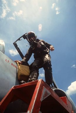 A pilot climbs out of the cockpit of an A-4 Skyhawk aircraft after completing a mission during Exercise COPE CANINE '85