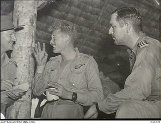 VIVIGANI, GOODENOUGH ISLAND, PAPUA NEW GUINEA. 1943-10-12. BEAUFIGHTER CREWS OF NO. 30 SQUADRON RAAF REPORT IN TO TELL THEIR STORY TO THE INTELLIGENCE OFFICER AFTER THE DAYLIGHT RAID ON RABAUL