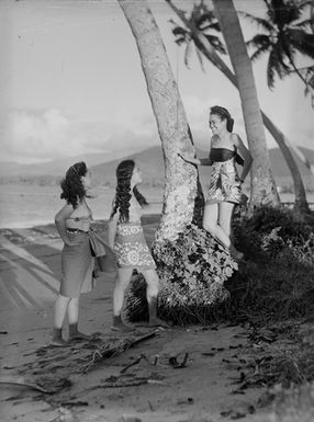 [Three Pacific Island girls on a shoreline]