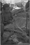 Mortuary ceremony: woman weaves long fiber skirt for ritual exchange