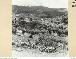 WAU - LAE ROAD, NEW GUINEA, 1944-02-20. THE REMAINS OF A CIVILIAN POWER-HOUSE VIEWED FROM THE ROAD APPROXIMATELY 5 MILES FROM WAU ON THE NORTH SIDE OF THE BULOLO RIVER. FCOMMANDOS DESTROYED THE ..