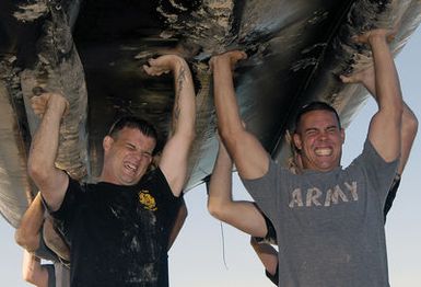 US service members from the Joint POW/MIA Accounting Command (JPAC) struggle to execute an overhead press their Zodiac raft during Zodiac training at Hickam Harbor, Hickam Air Force Base (AFB), Hawaii (HI). US Army's (USA) 7th Dive Detachment from Fort Schafter, HI, is conducting the training to increase the unit's readiness for water recovery missions. JPAC's mission is to achieve the fullest possible accounting of all Americans missing as a result of our nation's previous conflicts