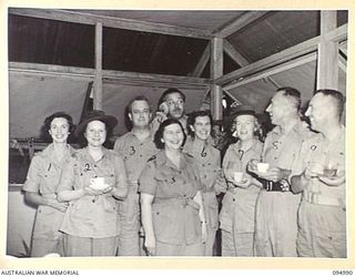 PALMALMAL, NEW BRITAIN. 1945-08-17. THE OFFICIAL PARTY WITH GRACIE FIELDS (7), NOTED LANCASHIRE VOCALIST AND COMEDIENNE HAVING MORNING TEA AT THE MATRON'S COTTAGE, 2/8 GENERAL HOSPITAL. IDENTIFIED ..