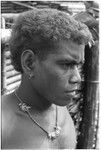 Portrait of boy with shell money and dolphin teeth necklace