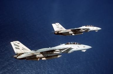 Two F-14A Tomcat aircraft of Fighter Squadron 154 (VF-154) perform a section roll off Saipan in the Mariana Islands