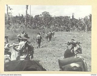 YAKAMUL, NEW GUINEA. 1945-01-09. MEMBERS OF THE 2/2ND INFANTRY BATTALION AND "JOCK FORCE" AND THEIR NATIVE CARRIERS LEAVING THEIR BASE CAMP AT THE START OF A 40 DAY PATROL THROUGH ENEMY OCCUPIED ..