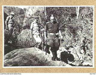 FARIA VALLEY, NEW GUINEA. 1943-11-14. MAJOR GENERAL J. S. LETHBRIDGE, CBE MC LEADER OF THE BRITISH MILITARY MISSION TO AUSTRALIA; (1) FOLLOWED BY VX9 MAJOR GENERAL G. A. VASEY, CB CBE DSO (2); AND ..