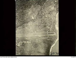 LAE, NEW GUINEA. 1942-09-19. AERIAL PHOTOGRAPH OF THE AIRSTRIP TAKEN DURING A BOMBING ATTACK BY ALLIED FORCES