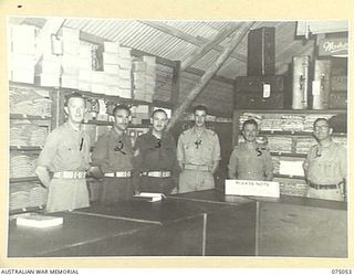 LAE, NEW GUINEA. 1944-08-07. THE OFFICE AND SHOP STAFF OF THE OFFICERS SHOP, HEADQUARTERS, NEW GUINEA FORCE. IDENTIFIED PERSONNEL ARE:- VX73565 CORPORAL H.S. WATSON (1); VX75547 CORPORAL C.E. RODER ..