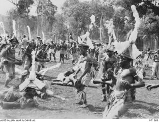 SONG RIVER, FINSCHHAFEN AREA, NEW GUINEA. 1944-03-26. FINSCHHAFEN BOYS DANCING DURING A NATIVE SING-SING IN THE AUSTRALIAN NEW GUINEA ADMINISTRATIVE UNIT COMPOUND TO CELEBRATE THE RE OCCUPATION OF ..