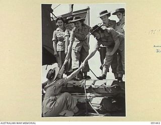 LAE, NEW GUINEA, 1945-05-07. MANY AUSTRALIAN WOMEN'S ARMY SERVICE PERSONNEL SOUGHT VANTAGE POINTS ON RAFTS ON THE DECKS OF THE MV DUNTROON TO WATCH DISEMBARKATION PROCEEDINGS. THEY ARE PART OF A ..