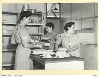 PORT MORESBY, PAPUA, 1944-02-20. STAFF OF THE AUSTRALIAN WOMEN'S SERVICES CLUB, CONDUCTED BY THE AUSTRALIAN ARMY CANTEENS SERVICE PREPARING AFTERNOON TEA IN THE KITCHEN. IDENTIFIED PERSONNEL ARE: ..