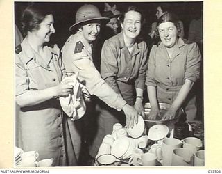 1942-11-11. AUSTRALIAN NURSES RETURN TO NEW GUINEA. WASHING-UP TIME IN THE MESS. LEFT TO RIGHT:- SISTER J. CAMERI, VICTORIA, MASSEUSE E. BISHOP, SYDNEY; SISTERS D. BUSH, N.S.W. AND M. HOLDING, ..