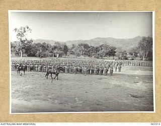 POM POM VALLEY, NEW GUINEA. 1943-11-30. 2/12TH AUSTRALIAN INFANTRY BATTALION, DRAWN UP IN "CLOSE COLUMN OF COMPANIES" ON THE SPORTSGROUND. IDENTIFIED PERSONNEL ARE: QX6073 MAJOR C. A. E. FRASER, ..