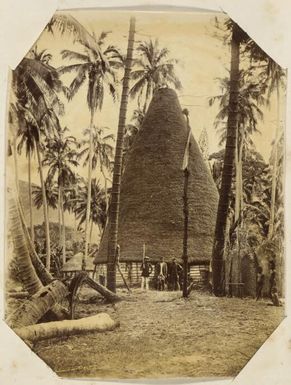 Three Kanak men, dressed in European clothing, in front of a native dwelling known as a grande case, New Caledonia, ca. 1870s / Allan Hughan