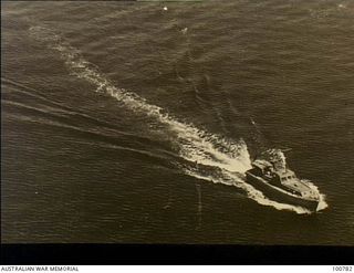 Torokina, Bougainville, 1945-04. An aerial photograph of the 38 foot Fast Supply Army Launch (AM1496) engaged in special intelligence duties in the Solomon to New Ireland area