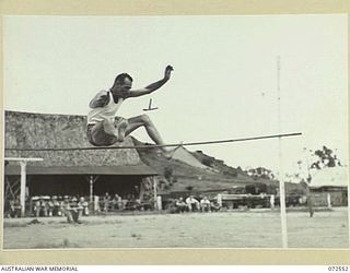 PORT MORESBY, NEW GUINEA. 1944-04-23. NX24774 PRIVATE D.A. DAVIS ATTEMPTING TO CLEAR 5 FEET 2 INCHES IN THE HIGH JUMP EVENT DURING THE 2/101ST GENERAL TRANSPORT COMPANY SPORTS MEETING HELD AT THE 9 ..