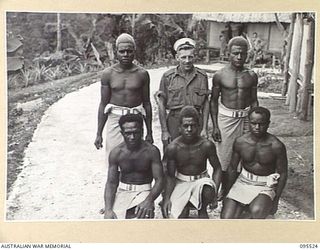 WUNUNG, JACQUINOT BAY, NEW BRITAIN, 1945-08-25. ABLE SEAMAN F.W. RIORDAN, ROYAL AUSTRALIAN NAVAL RESERVE COXSWAIN WITH THE CREW OF THE ALLIED INTELLIGENCE BUREAU SMALL SHIP MOTOR VESSEL GNAIR