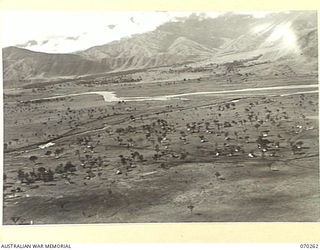 DUMPU, RAMU VALLEY, NEW GUINEA, 1944-02-10. AN AERIAL VIEW OF 7TH DIVISION SIGNAL HEADQUARTERS FROM A HEIGHT OF 300 FEET LOOKING SOUTH ACROSS THE URIA AND RAMU RIVERS. A RIVER JUNCTION OCCURS JUST ..