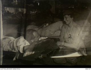 North Bougainville, Solomon Islands. 1945-03-31. Lady Wakehurst, wife of the Governor of New South Wales, speaking with NX36446 Private W.B. Ramsay, 55/53 Australian Infantry Battalion, during her ..