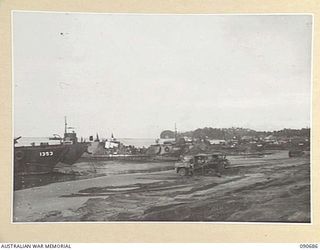 AITAPE, NEW GUINEA. 1945-04-19. SUPPLIES BEING UNLOADED FROM BARGES AT THE BEACH HEAD