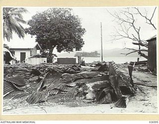 DEMOLISHED BUILDINGS AND STORAGE TANKS AT SAMARAI ISLAND, DESTROYED BY AUSTRALIAN MILITARY FORCES BEFORE EVACUATING THE ISLAND, WHICH IS SMALL AND OF LITTLE MILITARY VALUE. ALL INSTALLATIONS, ..