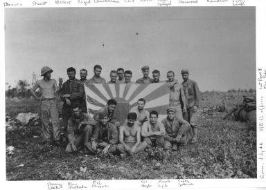 6th Marine Division Headquarters Company officers posing around a Japanese flag