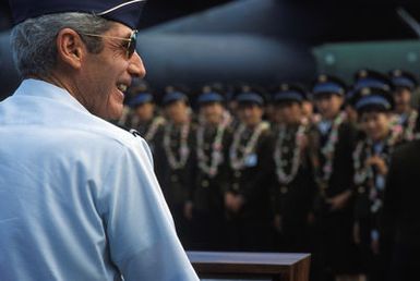 General (GEN) Robert W. Bazeley, commander in chief, Pacific Air Force, addresses the Chinese People's Liberation Army Air Force Song and Dance Troupe upon their arrival at the base. The troupe is here on the final stop of its US tour