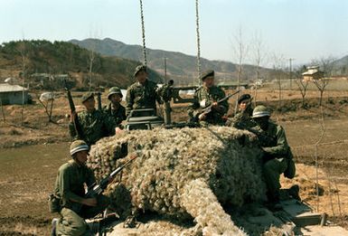Members of the 25th Infantry Division from Schofield Barracks, Hawaii, and members of the 2nd Republic of Korea Army Tank Battalion, stand by with an M-47 tank to defend against aggressor action from the Orange Forces. The U.S. and Korean soldiers are acting as members of the Blue Forces during the training exercise Team Spirit '82